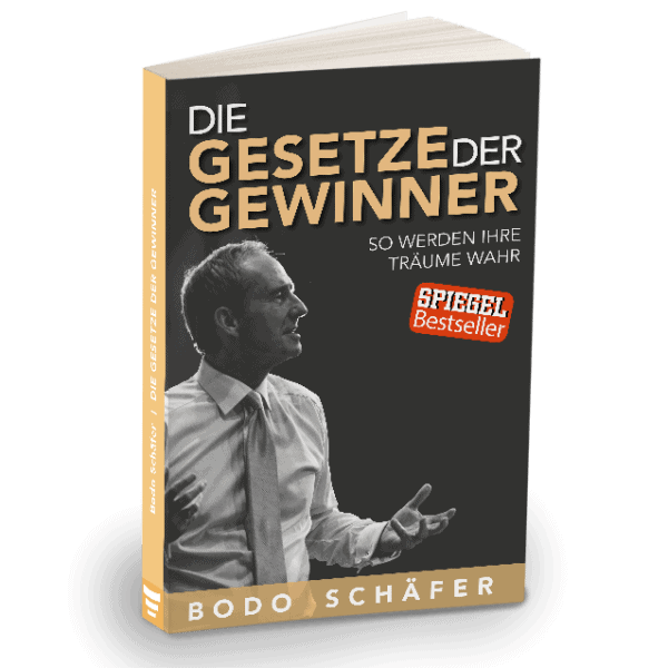 "Buchcover von 'Die Gesetze der Gewinner' von Bodo Schäfer. Das Cover zeigt einen Mann im Anzug, der nach vorne spricht und gestikuliert. Der Titel ist in großen goldenen und weißen Buchstaben geschrieben, mit dem Untertitel 'So werden Ihre Träume wahr'. Ein rotes Siegel mit der Aufschrift 'SPIEGEL Bestseller' ist ebenfalls auf dem Cover zu sehen.